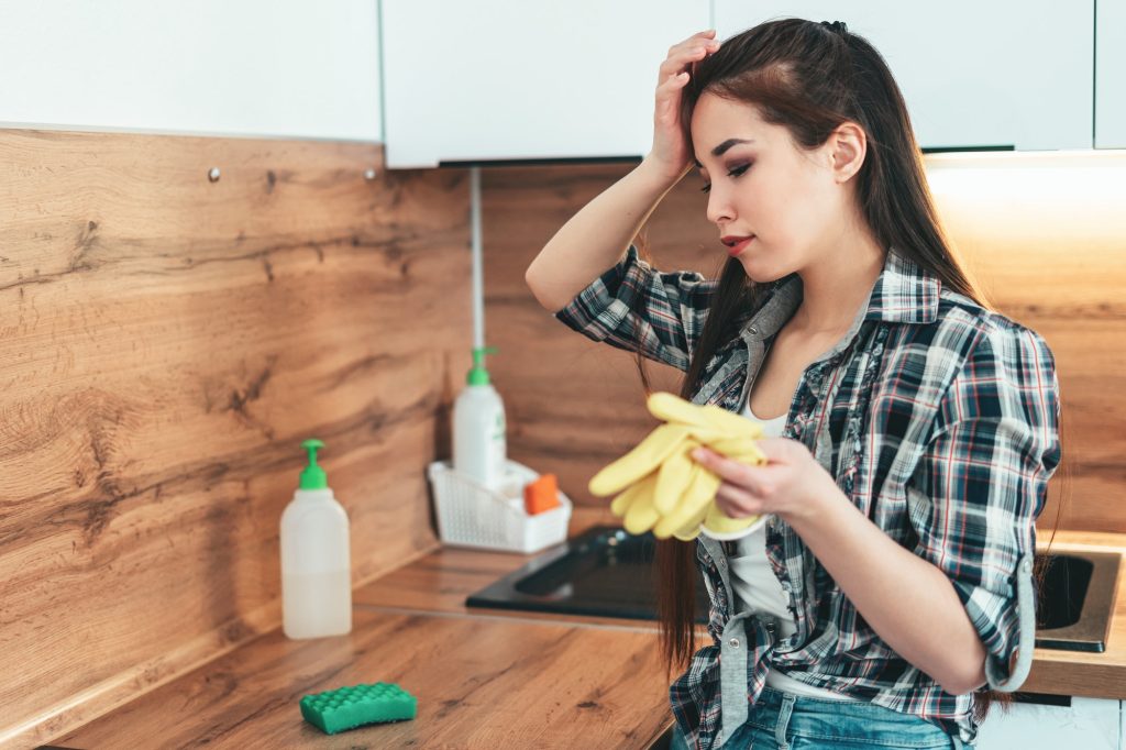 The girl is tired of washing the kitchen